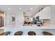 Open-concept kitchen featuring a large countertop with barstool seating, connecting to the dining area at 15060 W Hackamore Dr, Surprise, AZ 85387