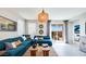 Comfortable living room showcasing a stylish couch, decorative lighting, and an open layout with natural light at 15060 W Hackamore Dr, Surprise, AZ 85387