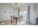 Dining room with a modern table and chairs under elegant lighting by a glass paneled door at 1851 W Vermont Ave, Phoenix, AZ 85015