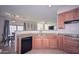 Charming kitchen featuring granite countertops, wood cabinets, and an open floorplan at 1851 W Vermont Ave, Phoenix, AZ 85015