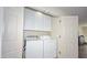 A convenient laundry closet featuring a washer, dryer, and overhead storage shelves at 1851 W Vermont Ave, Phoenix, AZ 85015