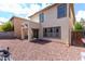Backyard featuring desert landscaping, a covered patio, and sliding glass doors to the home at 18525 W Valerie Dr, Surprise, AZ 85374