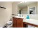 Bathroom featuring a white vanity, a large mirror, and a toilet at 18525 W Valerie Dr, Surprise, AZ 85374