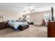 Spacious primary bedroom with a ceiling fan, natural light, and carpet flooring at 18525 W Valerie Dr, Surprise, AZ 85374