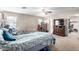 A bright primary bedroom featuring a ceiling fan, a mini refrigerator, and a closet at 18525 W Valerie Dr, Surprise, AZ 85374