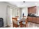 Bright dining area featuring laminate floors, a patio door and modern lighting at 18525 W Valerie Dr, Surprise, AZ 85374