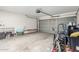 A spacious two-car garage with an automatic door and concrete flooring at 18525 W Valerie Dr, Surprise, AZ 85374