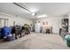Spacious garage with white walls, overhead lighting, and plenty of storage for tools and bins at 18525 W Valerie Dr, Surprise, AZ 85374