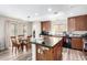 Lovely kitchen with dark laminate flooring, granite countertops, and modern appliances at 18525 W Valerie Dr, Surprise, AZ 85374