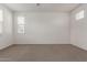 Spacious bedroom featuring neutral carpet and windows offering natural light at 1857 W 22Nd Ave, Apache Junction, AZ 85120