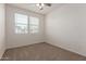 Bright bedroom features a ceiling fan and a window with blinds for natural light at 1857 W 22Nd Ave, Apache Junction, AZ 85120