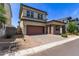 Two-story home featuring a two-car garage, desert landscaping, and a well-maintained exterior at 1857 W 22Nd Ave, Apache Junction, AZ 85120