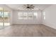 Bright living room featuring wood-look tile floors, a sliding door, and a ceiling fan at 1857 W 22Nd Ave, Apache Junction, AZ 85120