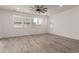 Bright living room featuring wood-look tile floors, recessed lighting, and a ceiling fan at 1857 W 22Nd Ave, Apache Junction, AZ 85120