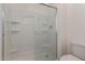 Shower enclosure with built-in shelving and glass doors adds a touch of elegance at 1857 W 22Nd Ave, Apache Junction, AZ 85120