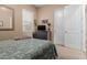 Well-lit bedroom with carpeted floor, a window with blinds, closet, and decorative mirror and wall art at 20556 W Point Ridge Rd, Buckeye, AZ 85396