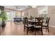 Open-concept dining and living area with tile floors, a ceiling fan, plenty of natural light and outdoor access at 20556 W Point Ridge Rd, Buckeye, AZ 85396