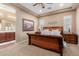 Comfortable main bedroom features a ceiling fan, a decorative painting, carpeted flooring, and ensuite bathroom access at 20556 W Point Ridge Rd, Buckeye, AZ 85396