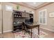 This home office features a built-in desk, overhead storage, and a window with plantation shutters at 20556 W Point Ridge Rd, Buckeye, AZ 85396