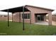 Backyard showcases a pergola, complemented by artificial turf, offering a low-maintenance outdoor living space at 21303 E Estrella Rd, Queen Creek, AZ 85142