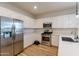 Modern kitchen with stainless steel appliances and white cabinets at 21303 E Estrella Rd, Queen Creek, AZ 85142