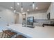 Bright kitchen with a quartz countertop island, stainless steel appliances, and white cabinets at 21303 E Estrella Rd, Queen Creek, AZ 85142