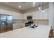 Bright kitchen with stainless steel appliances, white cabinets, and an island counter at 21303 E Estrella Rd, Queen Creek, AZ 85142