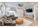 Relax in this living room offering recessed lighting, wood floors, and backyard views at 21303 E Estrella Rd, Queen Creek, AZ 85142