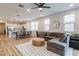Bright living room boasts wood floors, neutral decor, and an open floorplan to the kitchen at 21303 E Estrella Rd, Queen Creek, AZ 85142