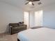 This bright main bedroom provides comfortable seating with a love seat at 21303 E Estrella Rd, Queen Creek, AZ 85142