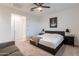 Enjoy this main bedroom's soft carpet, ceiling fan, and stylish decor at 21303 E Estrella Rd, Queen Creek, AZ 85142