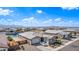 A bright aerial view of a cozy gray home with a large driveway and well maintained yard in a lakefront community at 22206 N Daniel Dr, Maricopa, AZ 85138