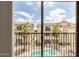Balcony view of a community featuring a pool, manicured landscaping, and beautiful architecture at 2315 N 52Nd St # 144, Phoenix, AZ 85008