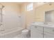 A bathtub, toilet, and single sink vanity with a mirror, all in a bright bathroom setting at 2315 N 52Nd St # 144, Phoenix, AZ 85008
