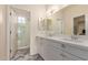 Bathroom featuring a double vanity, quartz countertops, and walk-in shower at 2315 N 52Nd St # 144, Phoenix, AZ 85008