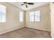Cozy bedroom with carpeted floors, a ceiling fan, and two windows offering plenty of natural light at 2315 N 52Nd St # 144, Phoenix, AZ 85008