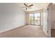 Spacious bedroom featuring carpet, a ceiling fan, and sliding glass doors to a balcony at 2315 N 52Nd St # 144, Phoenix, AZ 85008