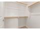 Walk-in closet with built-in shelving and wooden rods to optimize storage and organization at 2315 N 52Nd St # 144, Phoenix, AZ 85008