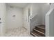 Bright entryway features marble tile flooring, white walls, and stairs with wood treads leading up at 2315 N 52Nd St # 144, Phoenix, AZ 85008