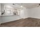 Open-concept view showcases the stainless steel appliances and quartz countertop in a kitchen with white cabinets at 2315 N 52Nd St # 144, Phoenix, AZ 85008