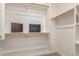 Walk-in closet with wooden rods and built-in shelving at 2315 N 52Nd St # 144, Phoenix, AZ 85008