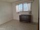 Bright bedroom featuring neutral walls, window with blinds, and a dresser at 2414 W Cholla St, Phoenix, AZ 85029