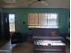 Inviting living room featuring vintage furniture, a ceiling fan, and good natural light at 2414 W Cholla St, Phoenix, AZ 85029