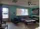 Cozy living room featuring vintage furniture, a ceiling fan, and good natural light at 2414 W Cholla St, Phoenix, AZ 85029