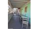 A screened-in porch with a dining table set and painted in green at 2414 W Cholla St, Phoenix, AZ 85029