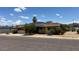 Street view of home with solar panels on the roof, well-maintained landscaping, and mountains in the background at 2414 W Cholla St, Phoenix, AZ 85029