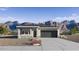 Charming one-story house with stone accents, a well-manicured lawn, and a two-car garage at 25096 N 154Th Ln, Surprise, AZ 85387