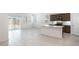 Open-concept kitchen with an island, stainless steel appliances, and a seamless flow into the adjacent living area at 25096 N 154Th Ln, Surprise, AZ 85387
