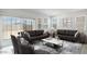 Inviting living room with comfortable seating, stylish decor, and large windows offering plenty of natural light at 25096 N 154Th Ln, Surprise, AZ 85387