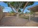 Backyard boasts desert landscaping, mature tree, and a covered patio at 2510 W Columbine Dr, Phoenix, AZ 85029